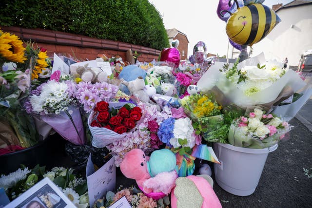 Floral tributes at the junction of Tithebarn Road and Hart Street in Southport (James Speakman/PA)