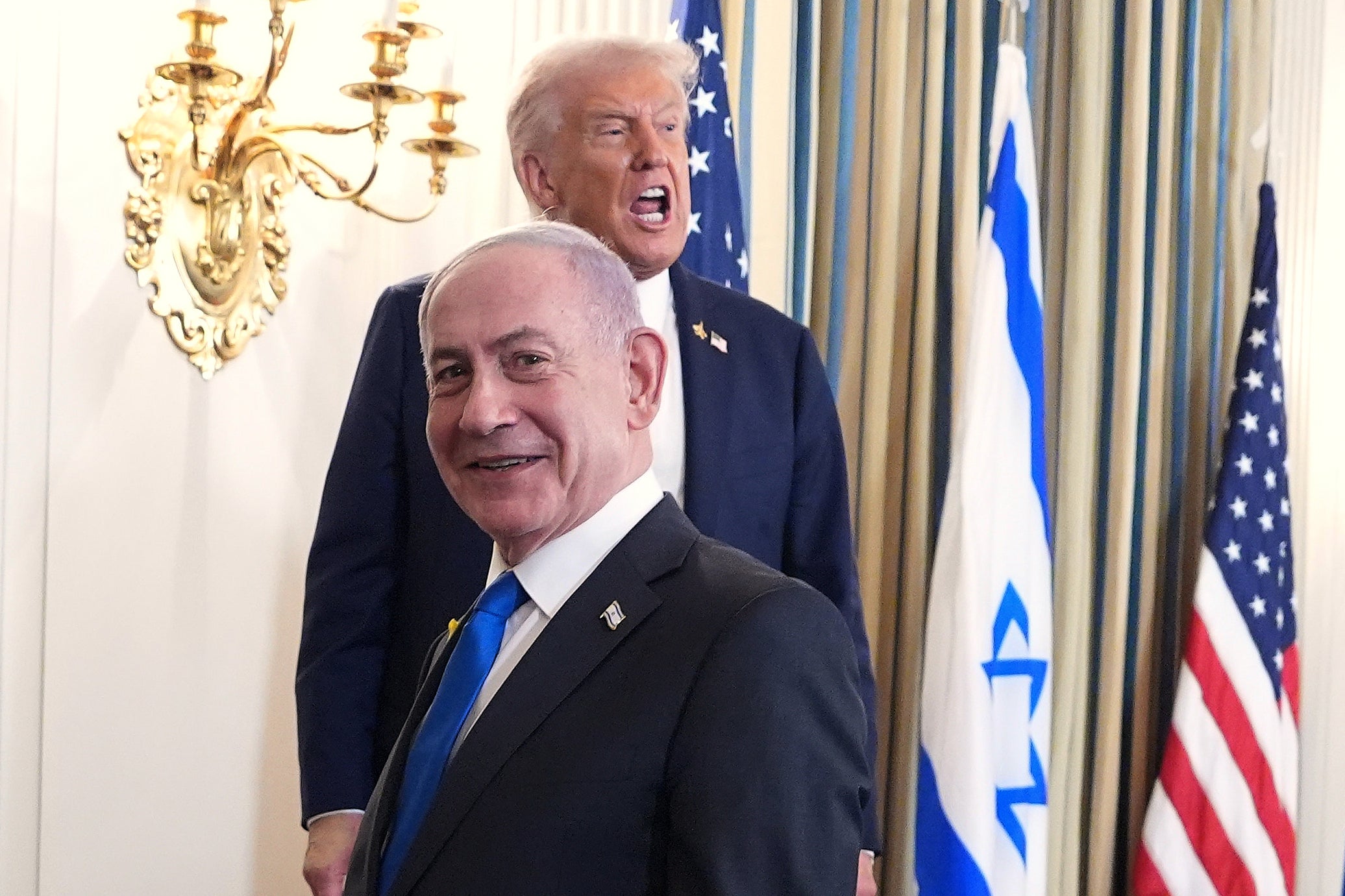 Donald Trump shouts to reporters during a press availability on Monday with Benjamin Netanayhu