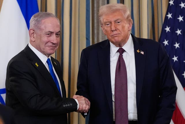 Israeli Prime Minister Benjamin Netanyahu shakes hands with President Donald Trump