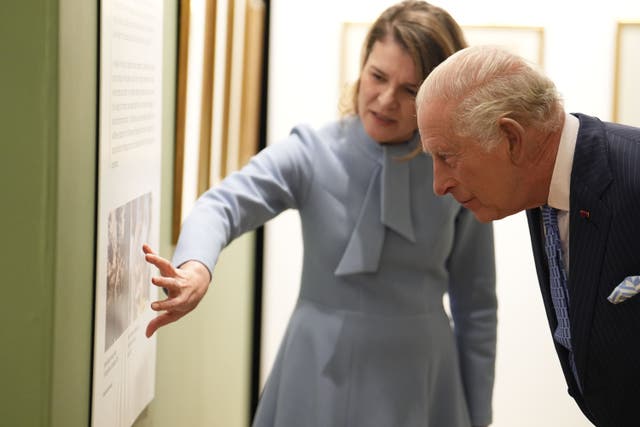 The King with Aura Woodward, director of the Romanian Cultural Institute in London, during a visit to view the Queen Marie of Romania exhibition at the Garrison Chapel in London (Jordan Pettitt/PA)