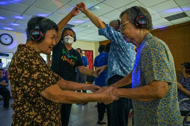 <p>People with dementia participate in a silent disco in Singapore</p>