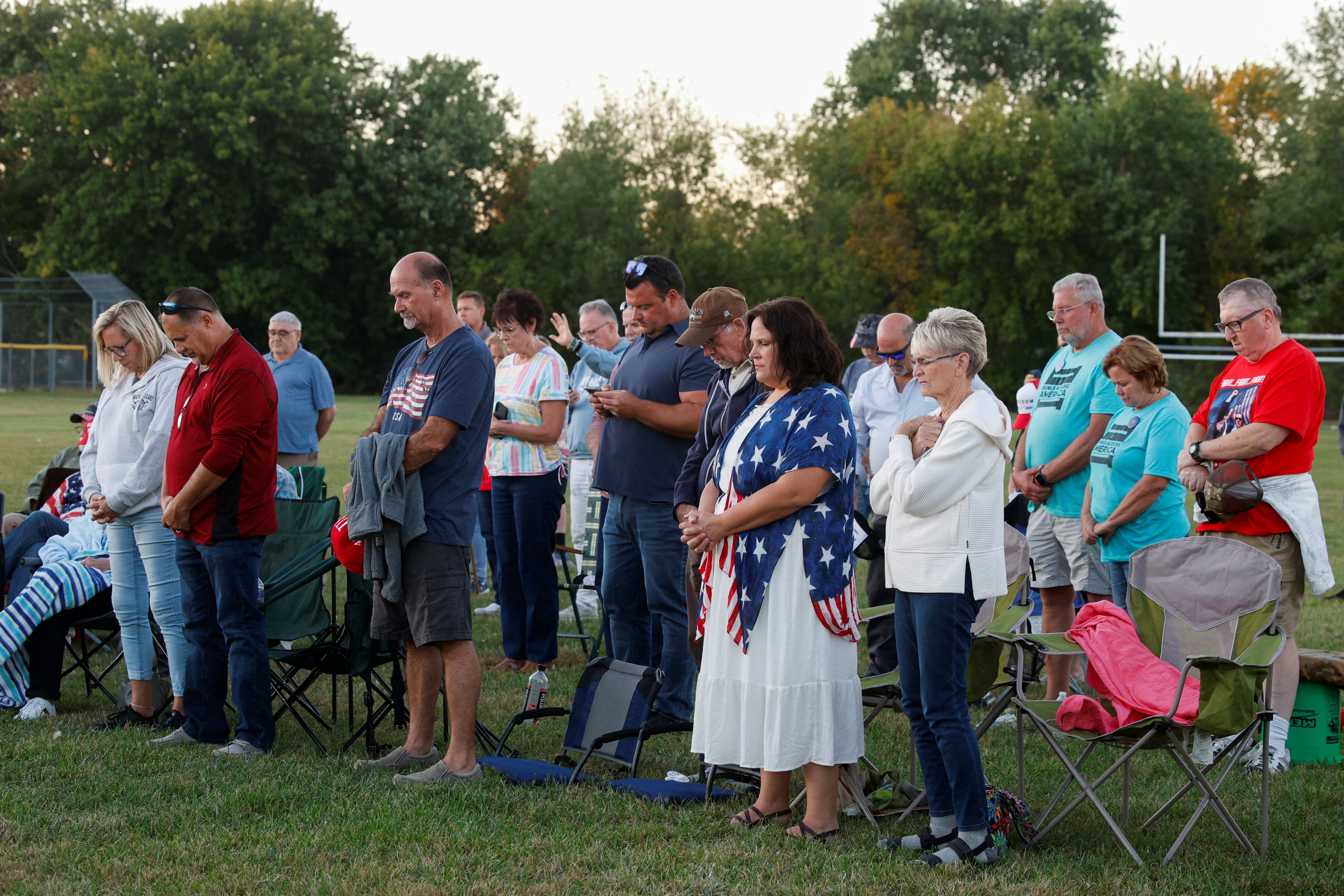 People attend a prayer vigil held against violence, in Burton