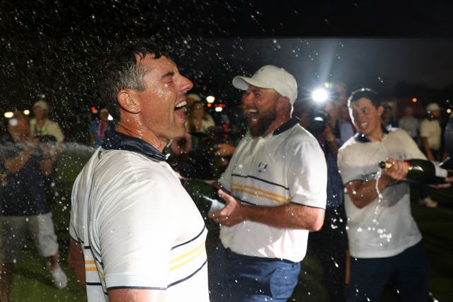 <p>Shane Lowry blasts Rory McIlroy with champagne as the party fires up</p>