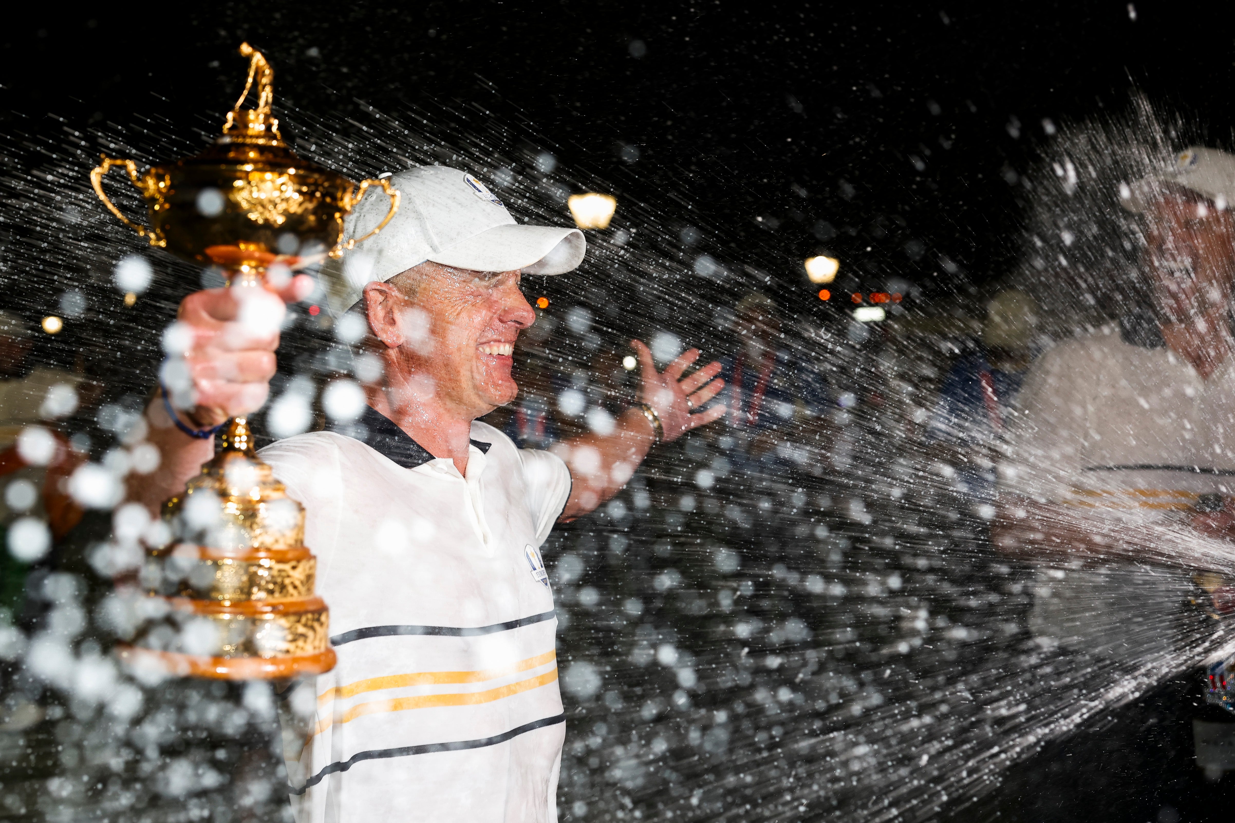 Luke Donald is soaked with champagne as he holds the trophy