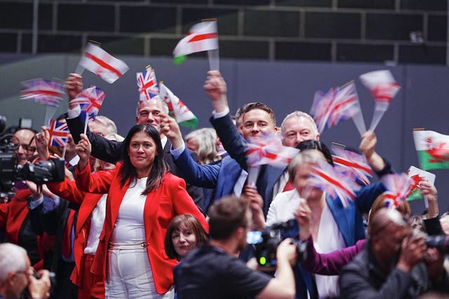 <p>Labour delegates wave flags in order to ‘reclaim’ them from acts of racism</p>