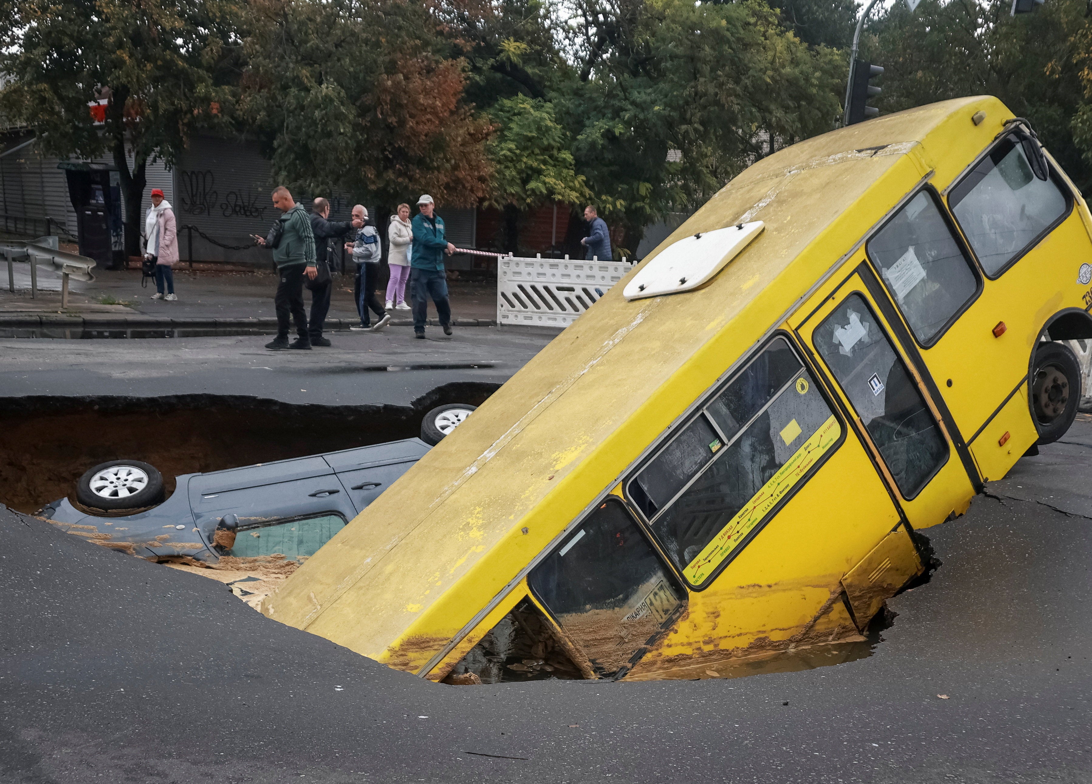 Emergency workers rescued people from a flood-struck bus