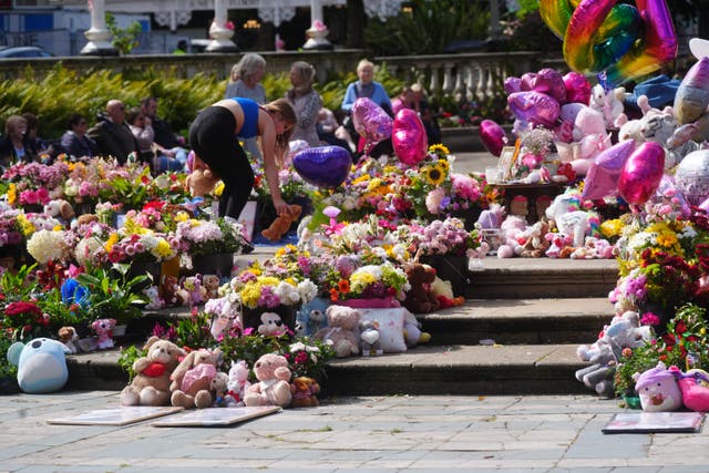 Flowers and tributes in Southport (Owen Humphreys/PA)