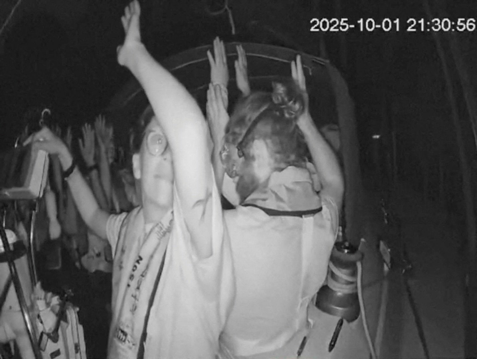 A screengrab from a live footage video shows crew of a Gaza-bound vessel, part of the Global Sumud Flotilla, put their hands up as they are intercepted by Israeli security forces