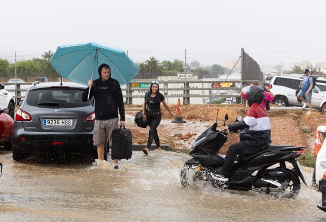 <p>A scooter drives through water on a flooded street on Sant Jordi on the island of Ibiza on September 30, 2025</p>