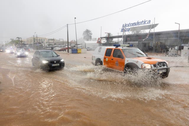 <p>A civil protection vehicle drives through a flooded street in Sant Jordi, Ibiza </p>