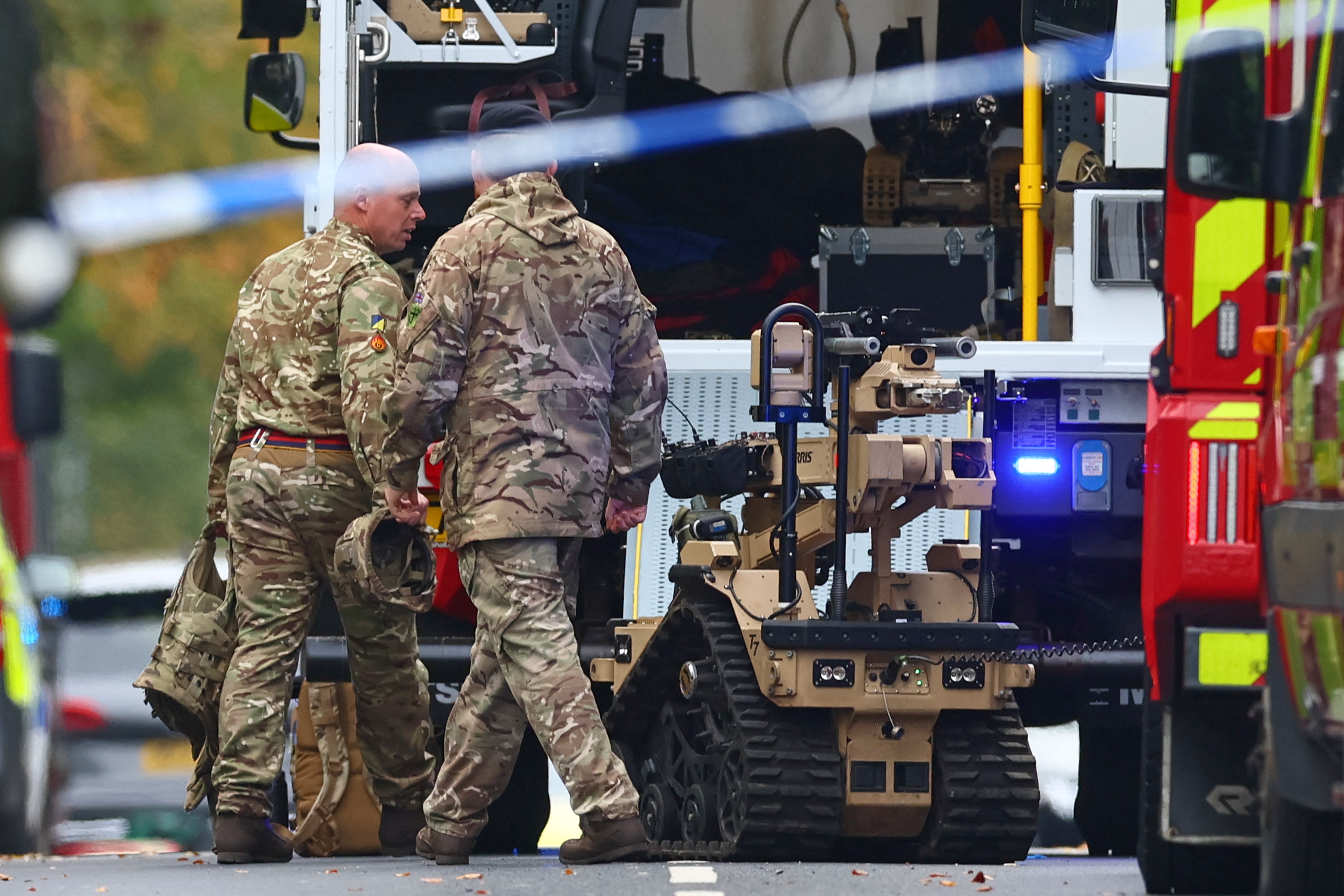 Army members prepare a bomb settlement robot inside a cordon outside the syllabus in the order.