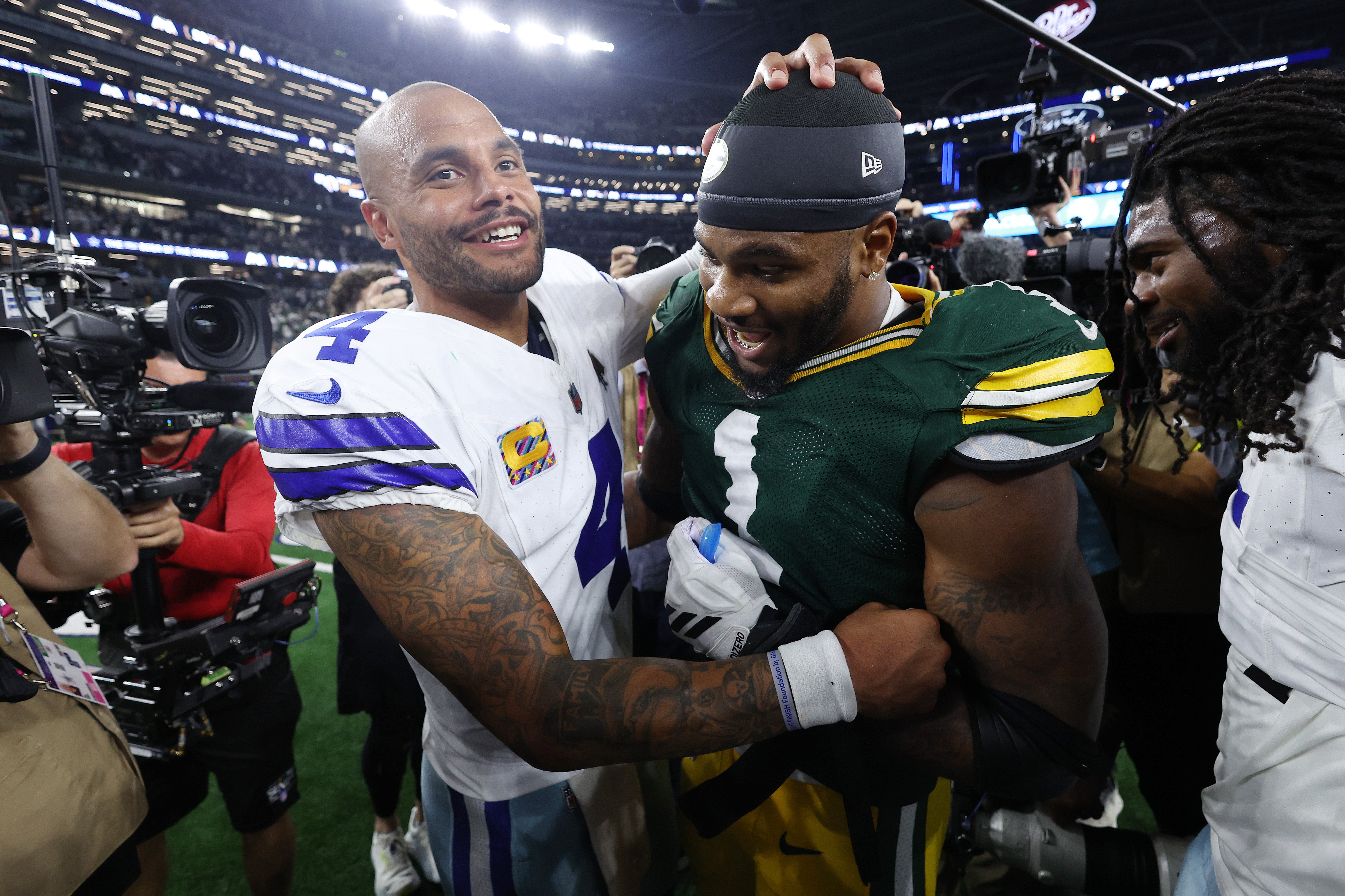 <p>Dak Prescott of the Dallas Cowboys embraces Green Bay Packers’ Micah Parsons after a tie game in overtime on Sunday</p>