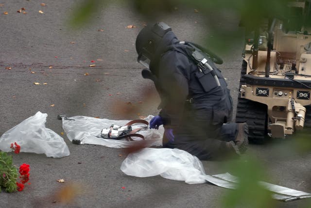 <p>A bomb disposal technician secures evidence at the scene</p>