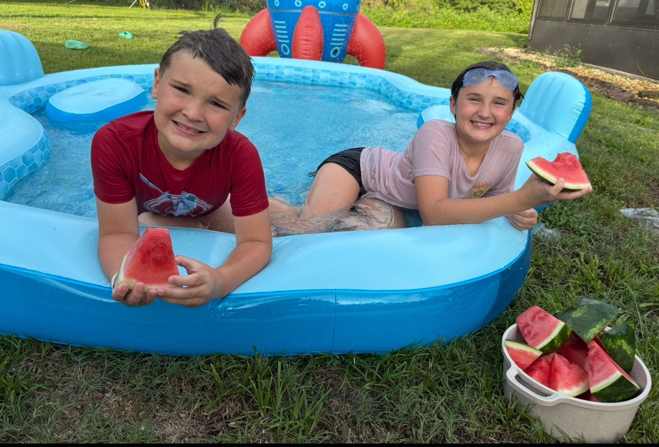 Courtney Schultz’s kids sitting in the pool in their backyard