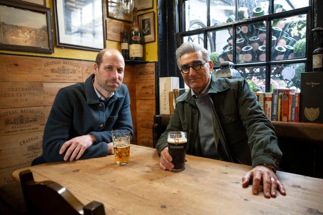 Undated handout photo issued by AppleTV+ of Eugene Levy sharing a pint with the Prince Of Wales (Ian Gavan/AppleTV+/PA)