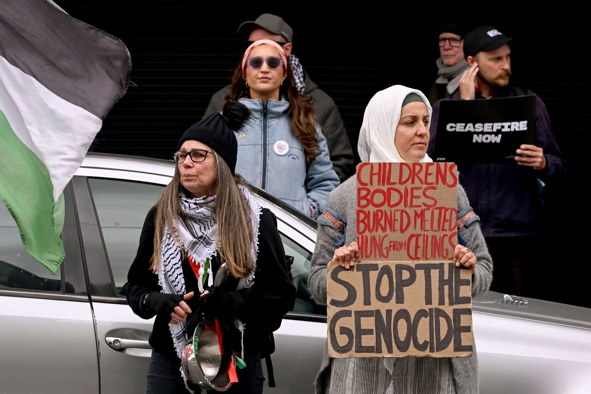 People hold placards at a rally supporting Australians onboard the Global Sumud Flotilla attempting to deliver aid to Gaza and calling on the Australian government's support, in Melbourne on 1 October 2025