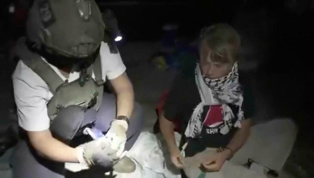 <p>Footage shows Greta Thunberg, right, being removed after Israeli navy intercepted the Global Sumud Flotilla carrying humanitarian aid towards Gaza </p>