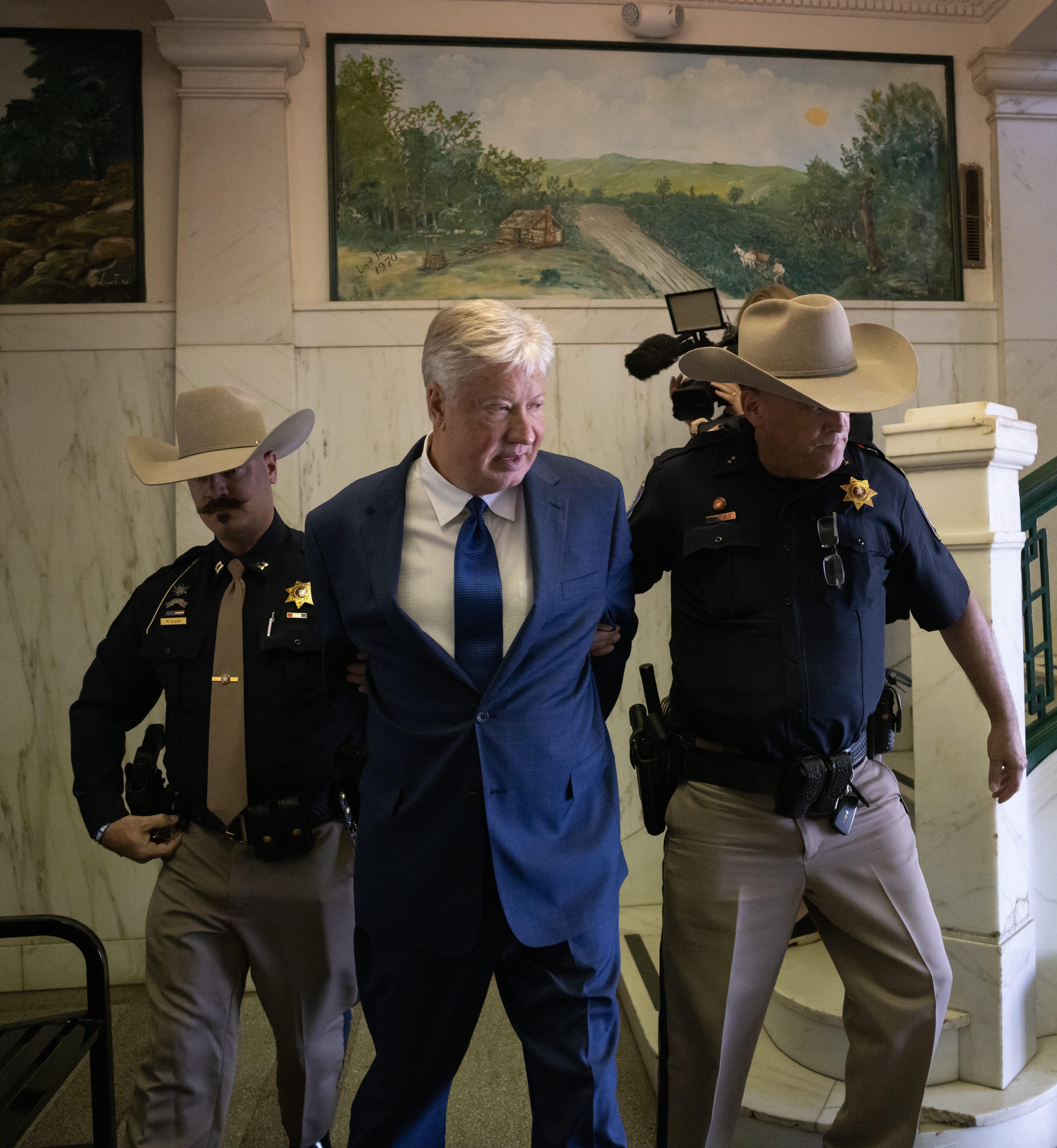 <p>Texas megachurch founder Robert Morris is escorted out of the courthouse after pleading guilty to lewd and indecent acts with a child</p>