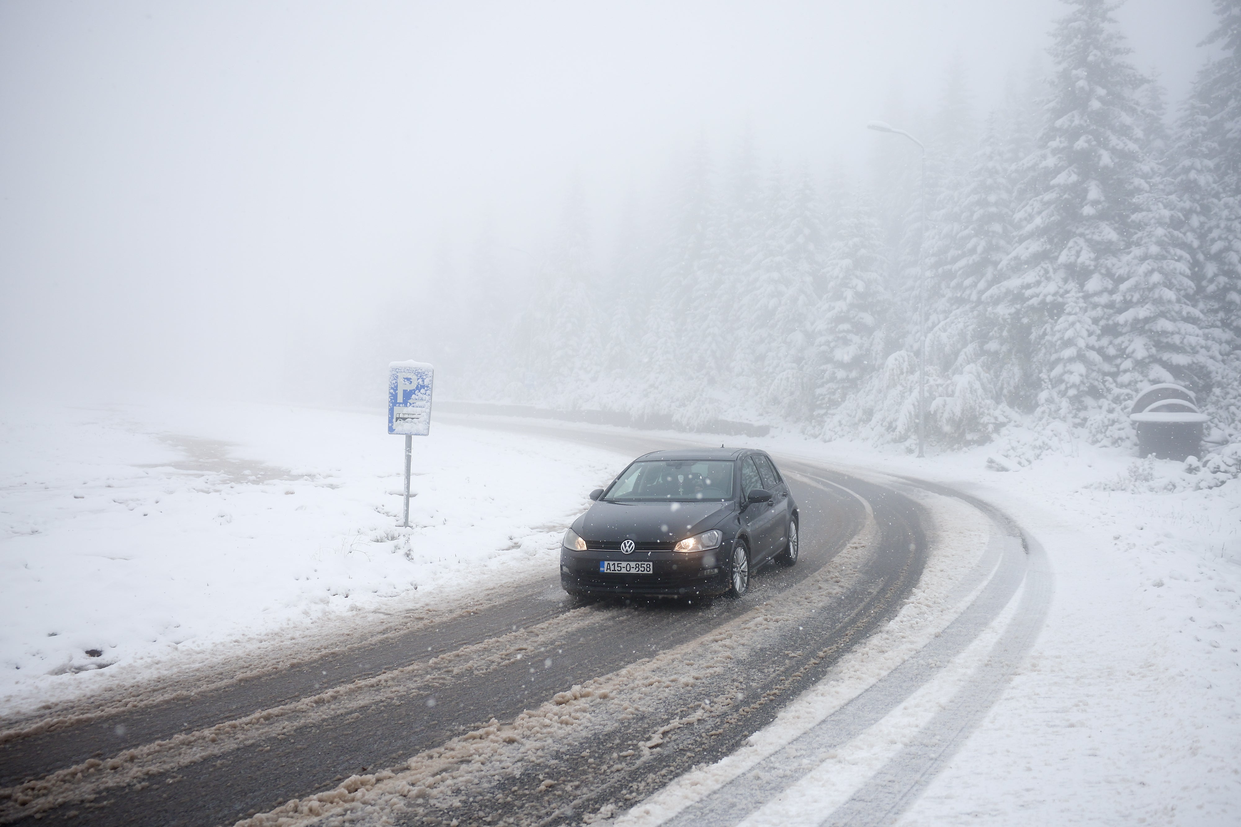 <p>A car drives along a road during an unexpected snowfall on mountain Jahorina near Sarajevo, Bosnia, Thursday, Oct. 2, 2025. (AP Photo/Armin Durgut)</p>