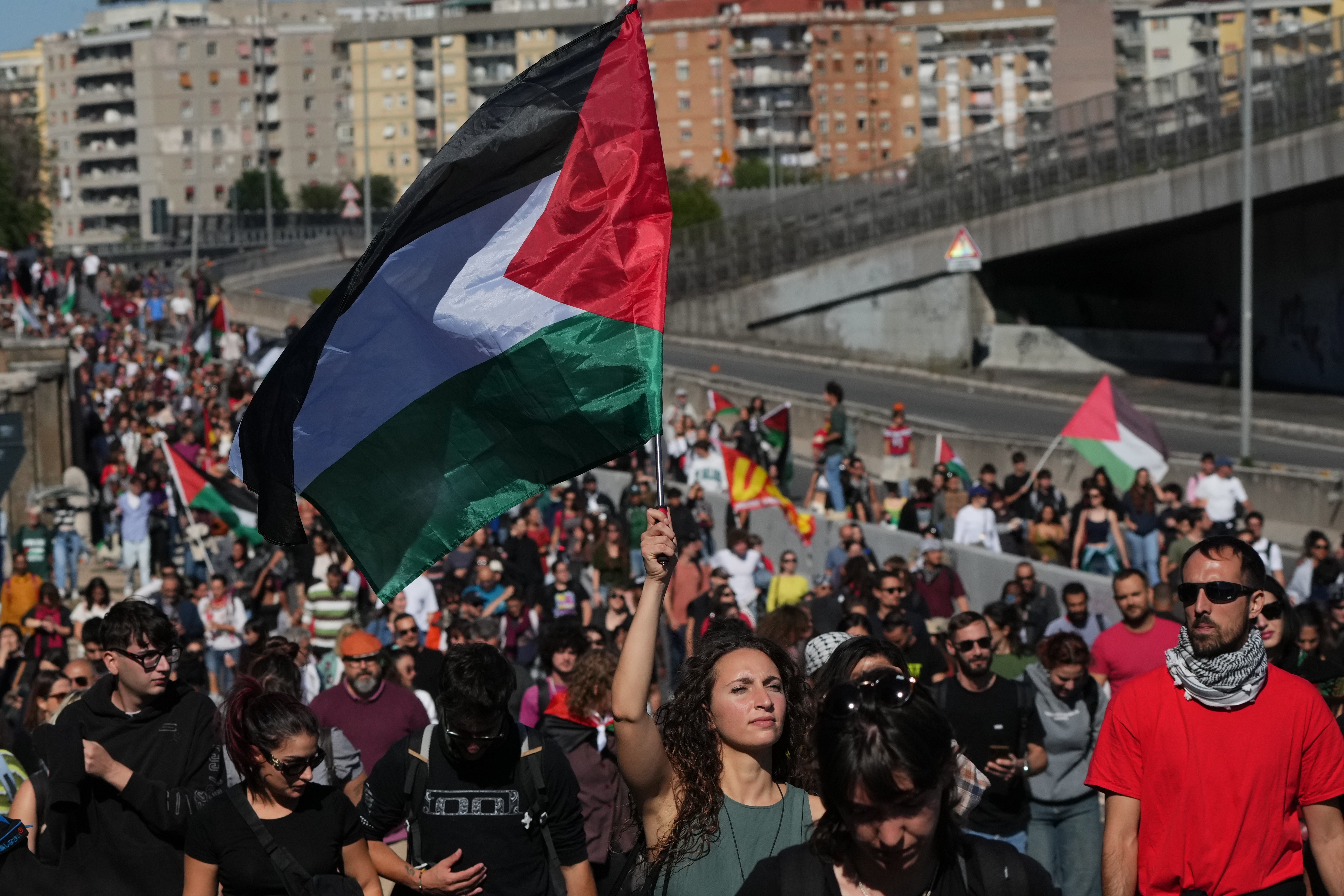 Pro-Palestinian demonstrators march along the Rome's ring road as they gather for a national general strike called by different unions to protest against the situation in Gaza two days after Israeli forces intercepted a Gaza-bound aid flotilla in the Mediterranean Sea, in Rome, Friday, Oct. 3, 2025. (AP Photo/Alessandra Tarantino)