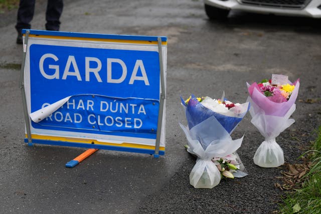 Flowers at the scene in Dromgowna, outside Tallanstown village after three members of the same family were found dead (Niall Carson/PA)