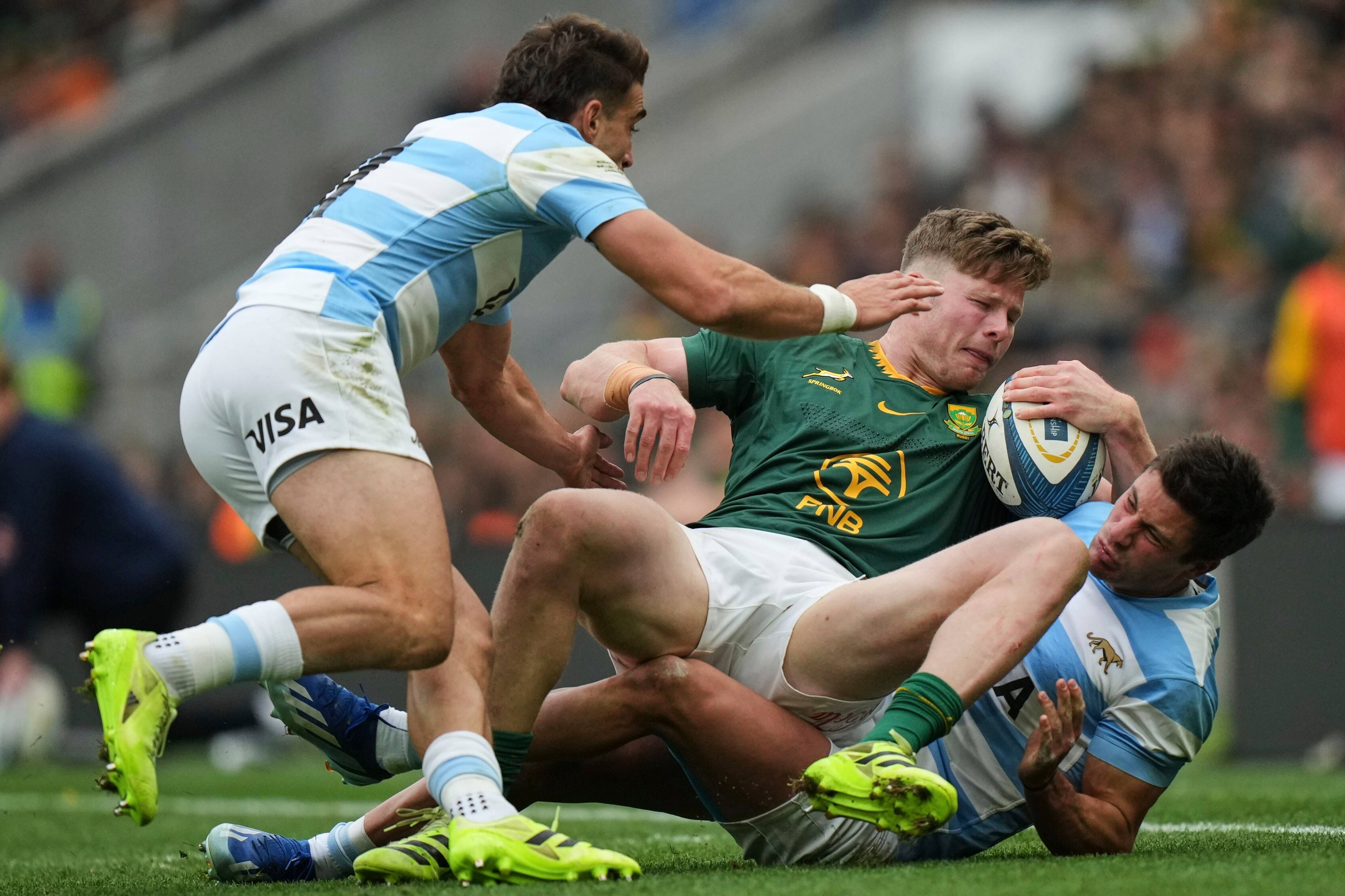 <p>South Africa's Ethan Hooker, center, is tackled by Argentina's Bautista Delguy, right, and teammate Juan Cruz MallÃ­a during the Rugby Championship match between Argentina and South Africa </p>
