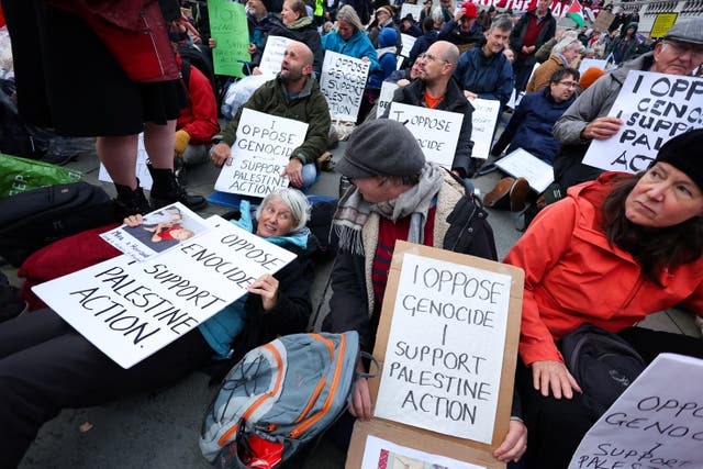 <p>Protesters hold placards during a mass demonstration organised by Defend our Juries</p>