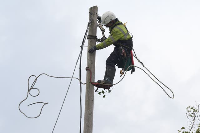 Electricity Supply Board (ESB) network technician Mark Lennon carries out repairs to fallen power cables in Balbriggan (Brian Lawless/PA)