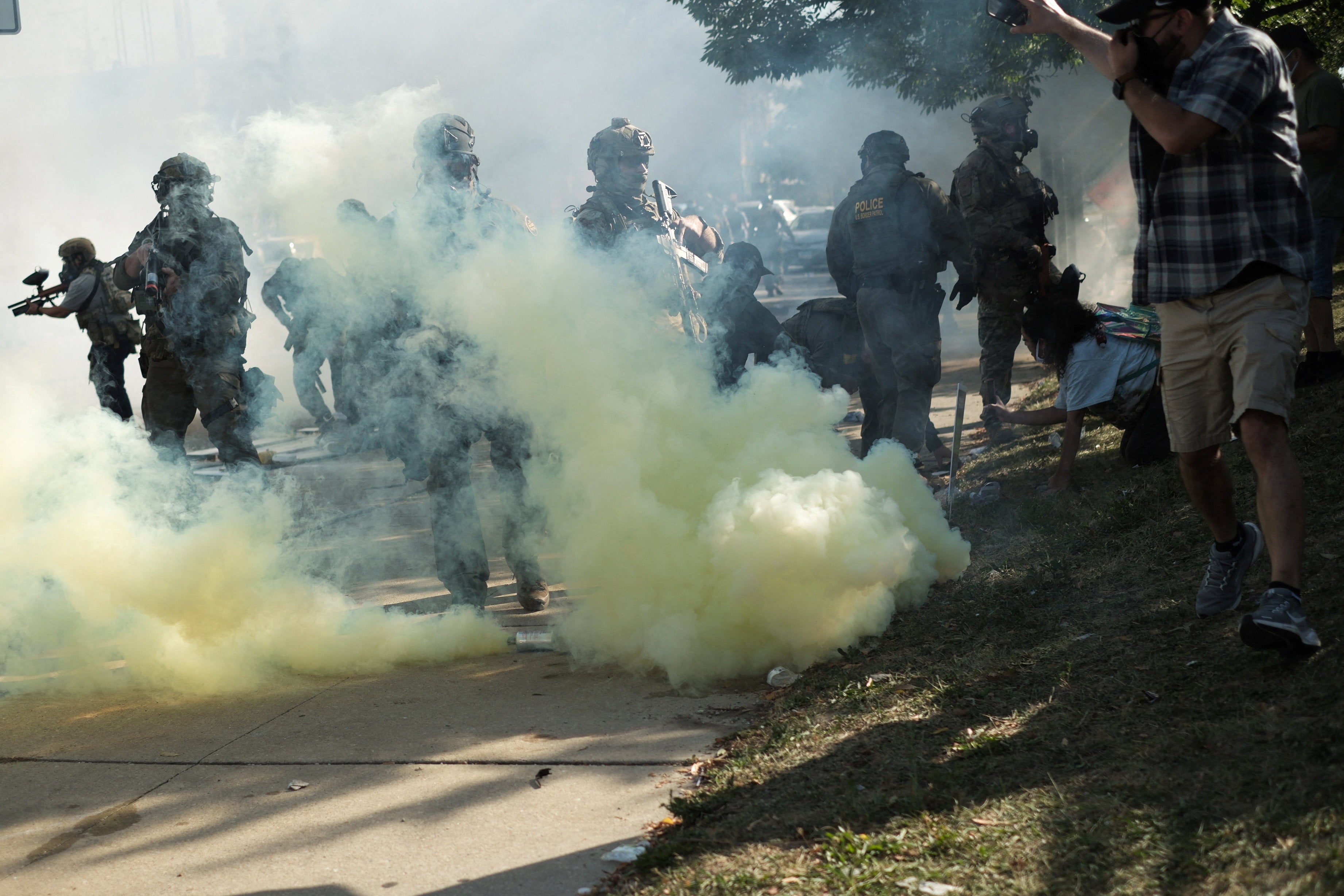 Law enforcement officers operate amid tear gas during a standoff with U.S. Immigration and Customs Enforcement (ICE) and federal officers in the Little Village neighborhood of Chicago, Illinois on October 4