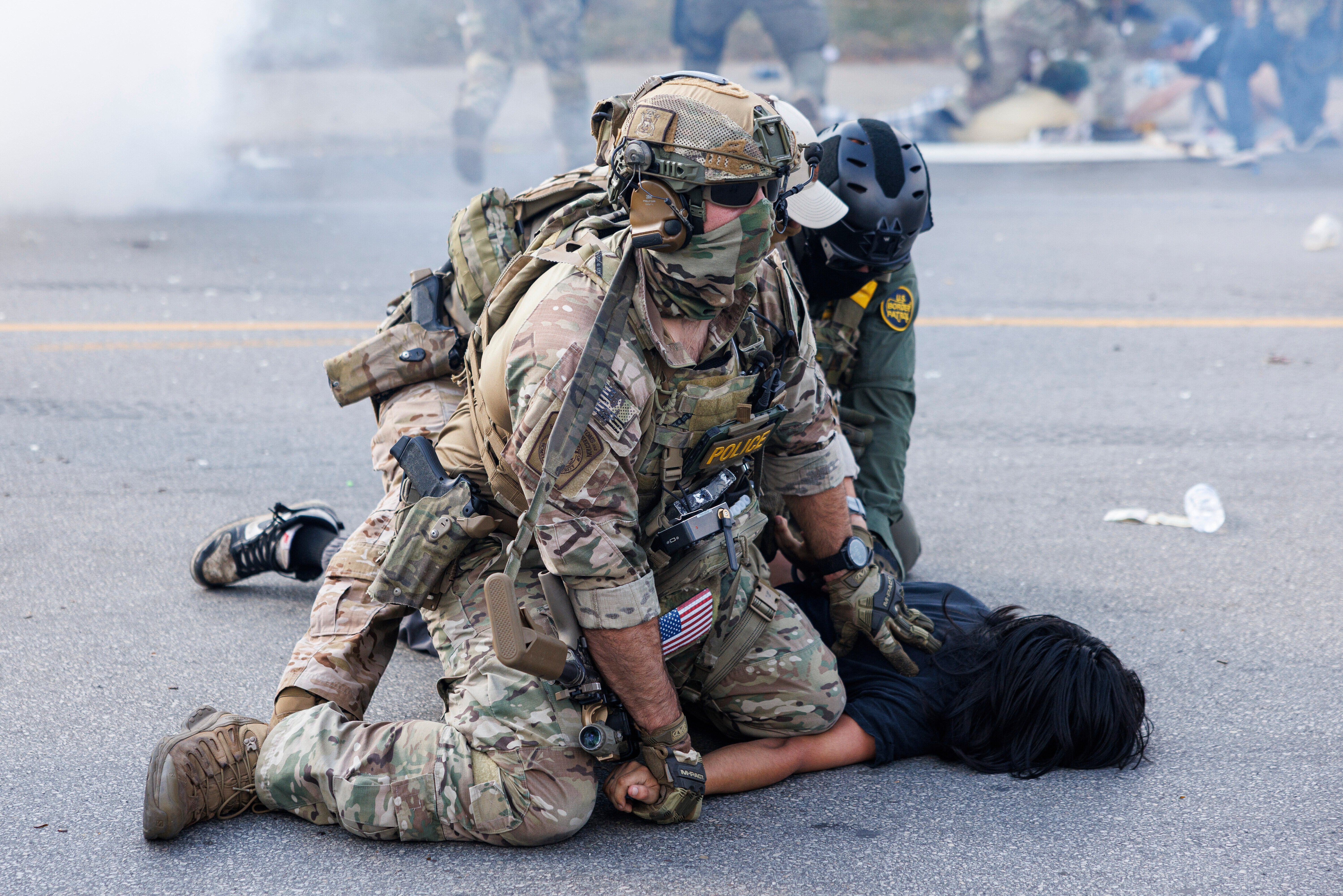 Federal officers hold down a protestor in the Brighton Park neighborhood of Chicago, on Saturday, Oct. 4, 2025, after protesters learned that U.S. Border Patrol shot a woman Saturday morning on Chicago's Southwest Side