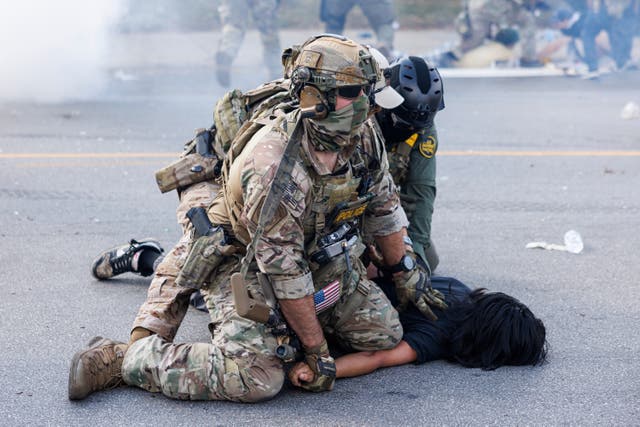 <p>Federal officers hold down a protestor in the Brighton Park neighborhood of Chicago, on Saturday, Oct. 4, 2025, after protesters learned that U.S. Border Patrol shot a woman Saturday morning on Chicago's Southwest Side</p>