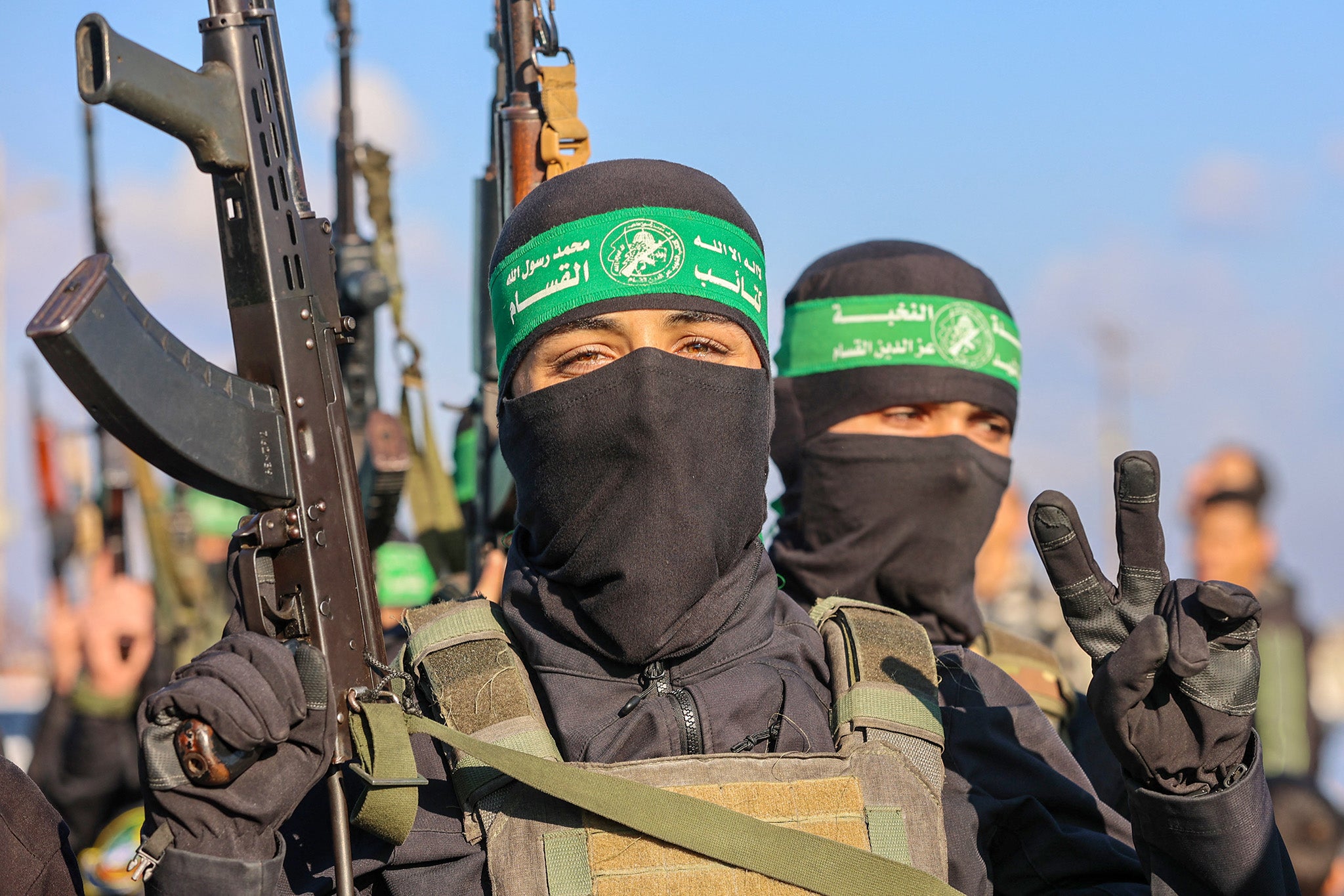 Palestinian militant group Hamas fighters secure an area before handing over an Israeli-American hostage to a Red Cross team in Gaza City on February 1, 2025, as part of the fourth hostage-prisoner exchange