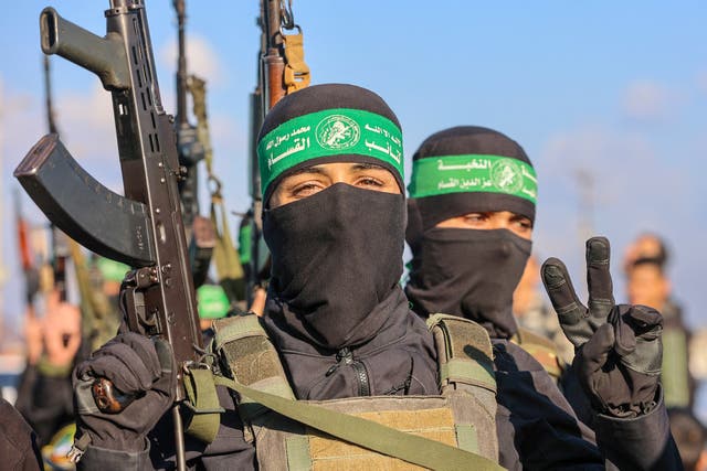 <p>Hamas militants secure an area before handing over an Israeli-American hostage to a Red Cross team in Gaza City on February 1, 2025, as part of the fourth hostage-prisoner exchange</p>