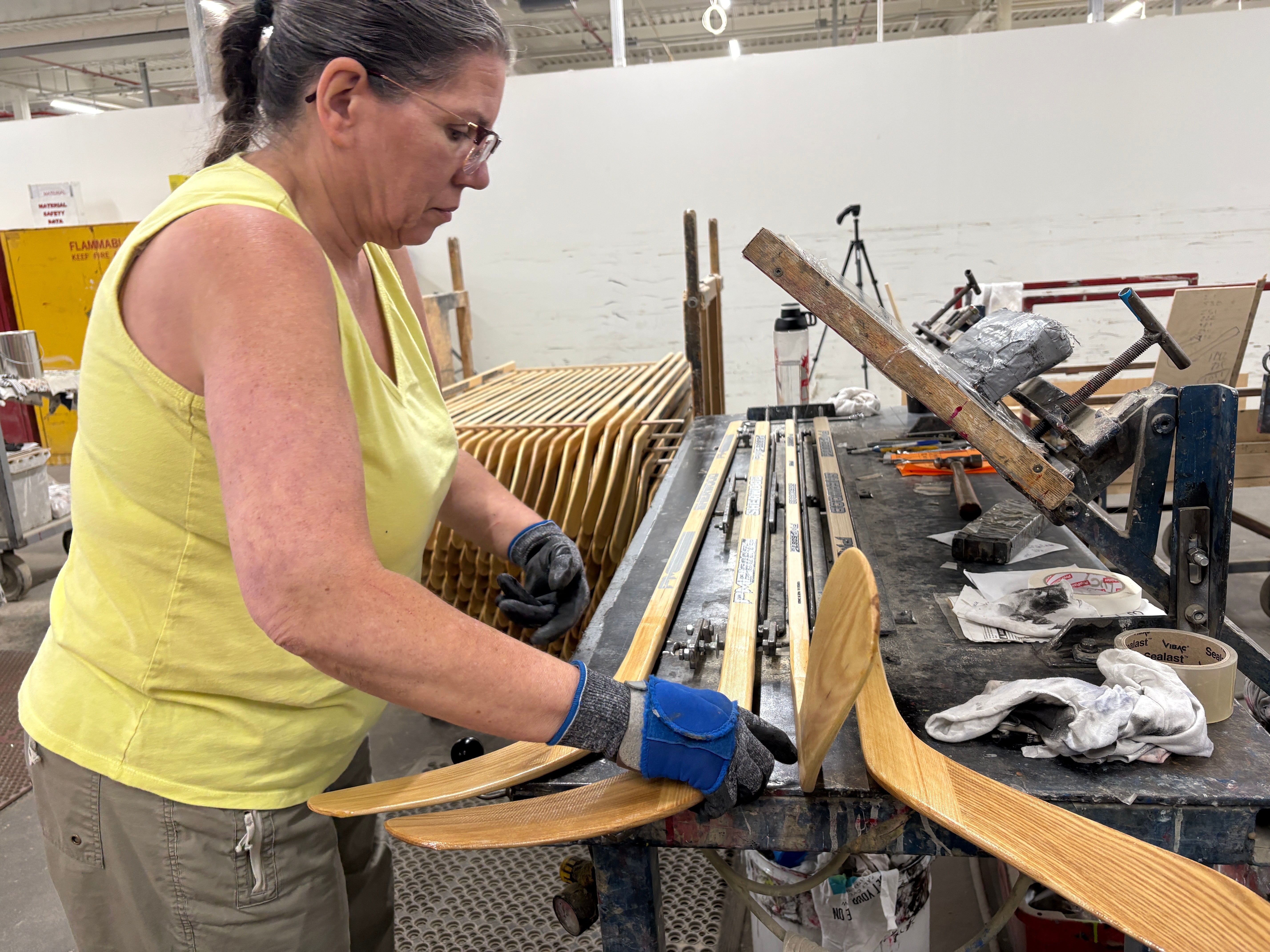 <p>A worker makes wooden hockey sticks at the Roustan Hockey factory – the last major manufacturer of hockey sticks in Canada</p>