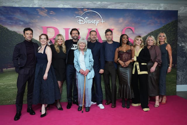 From left, Rivals cast Aidan Turner, Katherine Parkinson, Emily Atack, David Tennant, Jilly Cooper, Danny Dyer, Alex Hassell, Nafessa Williams, Bella Maclean, Claire Rushbrook and Victoria Smurfit attending the UK special screening of the first series (Lucy North/PA)