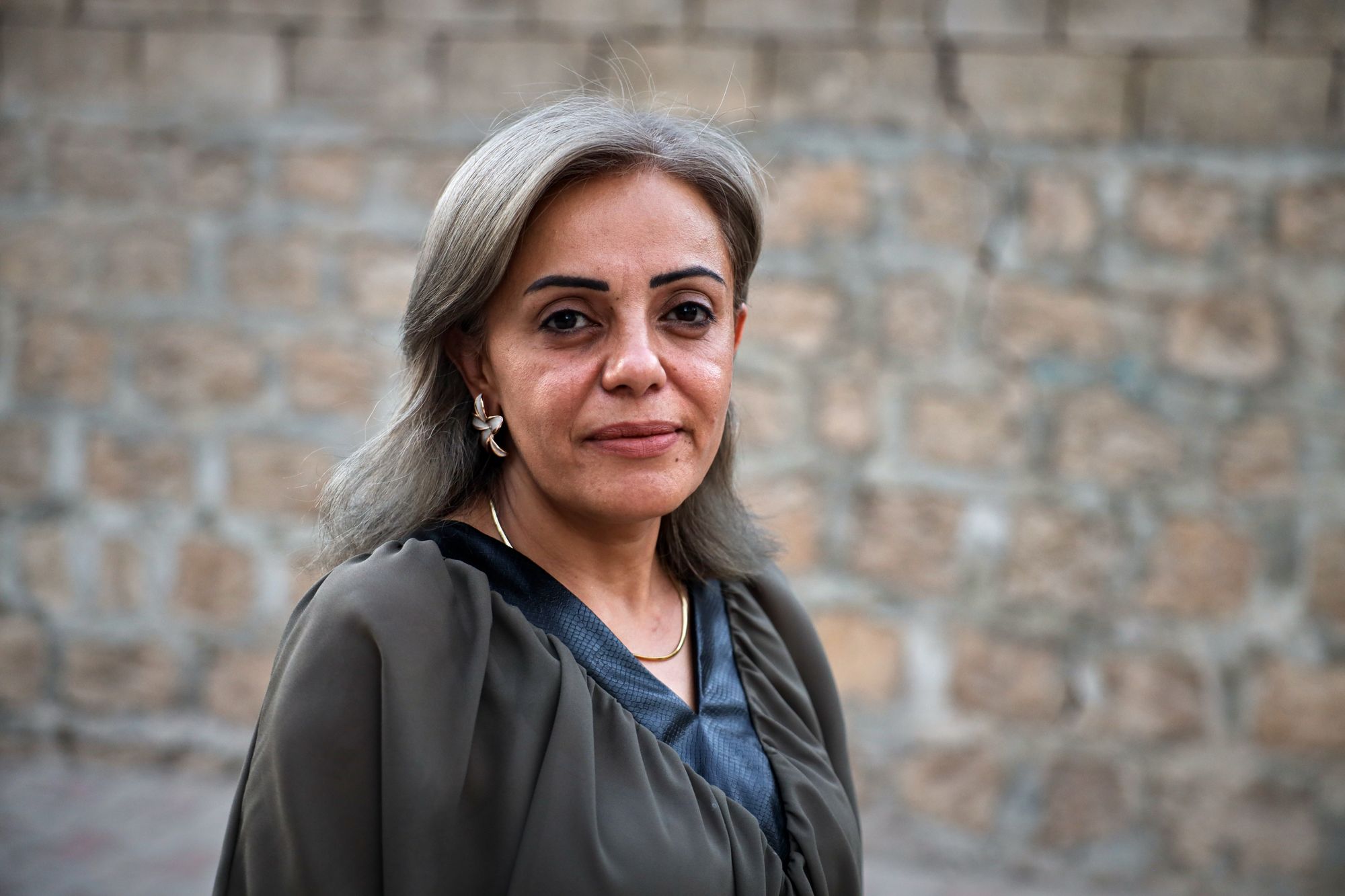 Kurdish health worker Dr Rankin Abdow poses for a photo after winning a seat for the Afrin region in Syria's parliamentary election