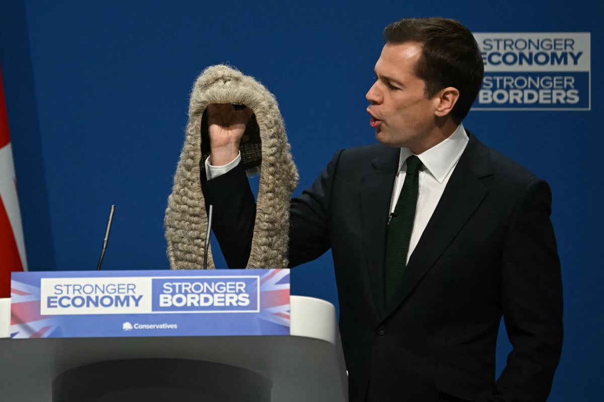 Jenrick brandishes judge’s wig at Tory conference as he attacks judiciary for ‘fighting to keep illegal migrants in the UK’