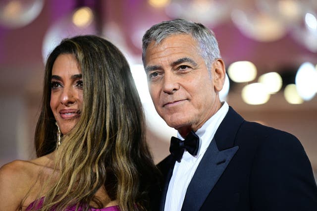 <p>US actor George Clooney and his wife Amal Clooney walk the red carpet before the screening of the movie "Jay Kelly" presented in competition at the 82nd International Venice Film Festival</p>