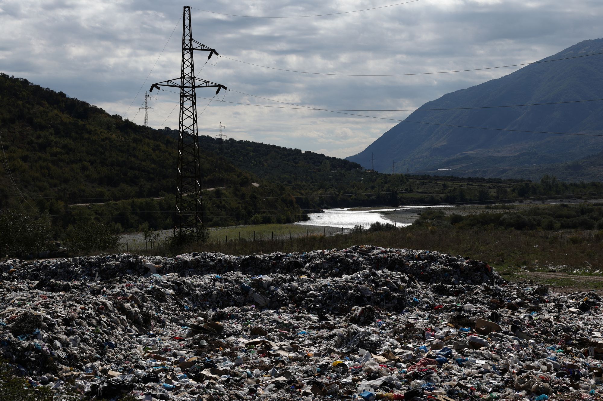 One local towards the landfill in the Vjosa valley where plastic is kicked up by the wind and caught by the branches of nearby trees