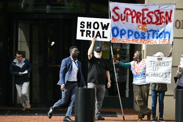 <p>Demonstrators outside a federal court in Alexandria, Virginia protested against the charges as Comey made his first appearance in federal court October 8</p>