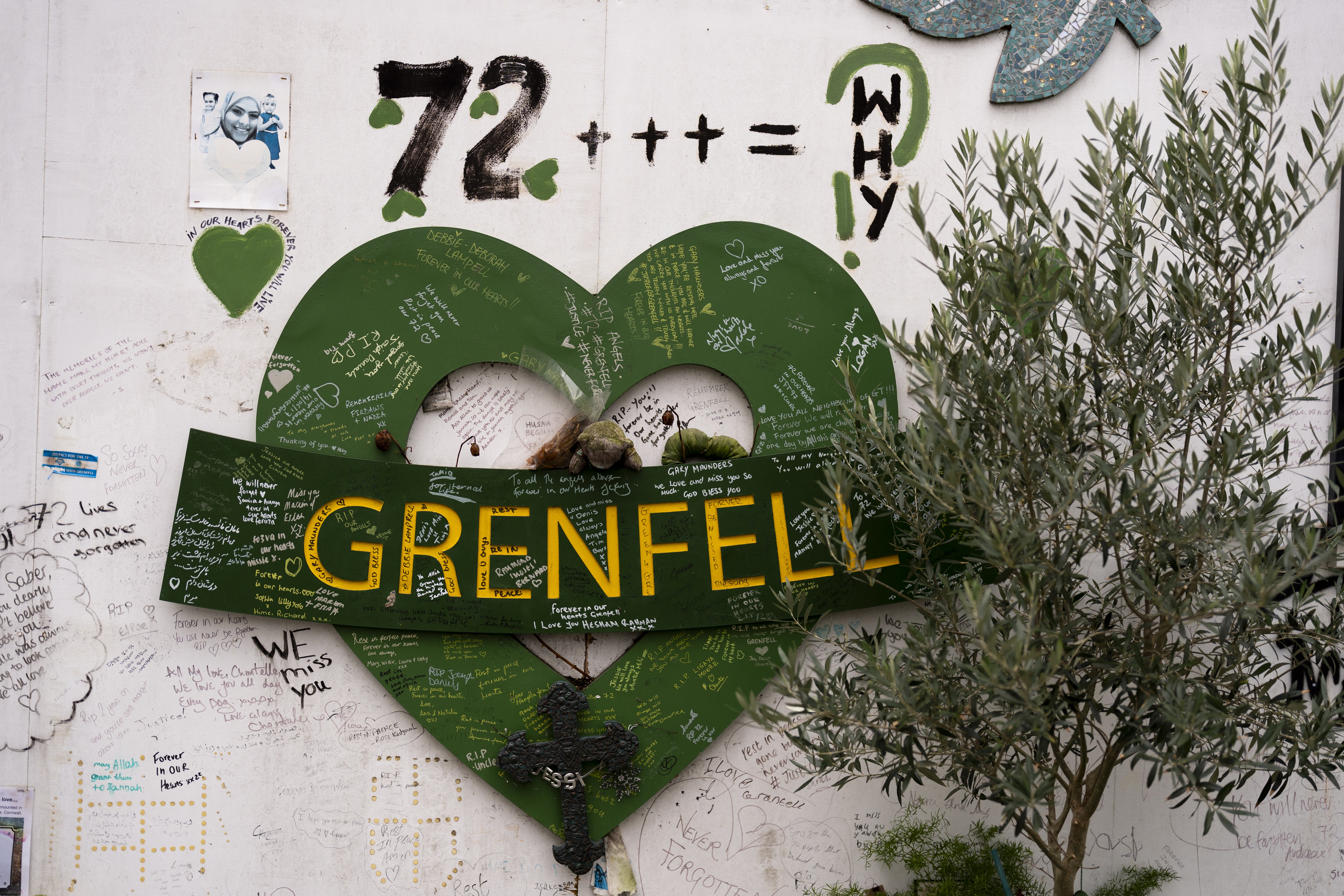 A memorial at the base of Grenfell left for the 72 people who lost their lives in the fire