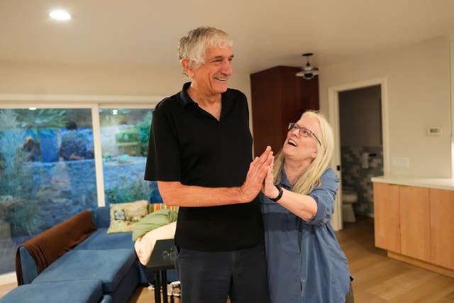 <p>John Martinis stands with his wife Jean in their living room after winning the Nobel Prize in Physics for his work on quantum tunneling on Tuesday, Oct. 7, 2025, in Santa Barbara, Calif. (AP Photo/Mark J. Terrill)</p>