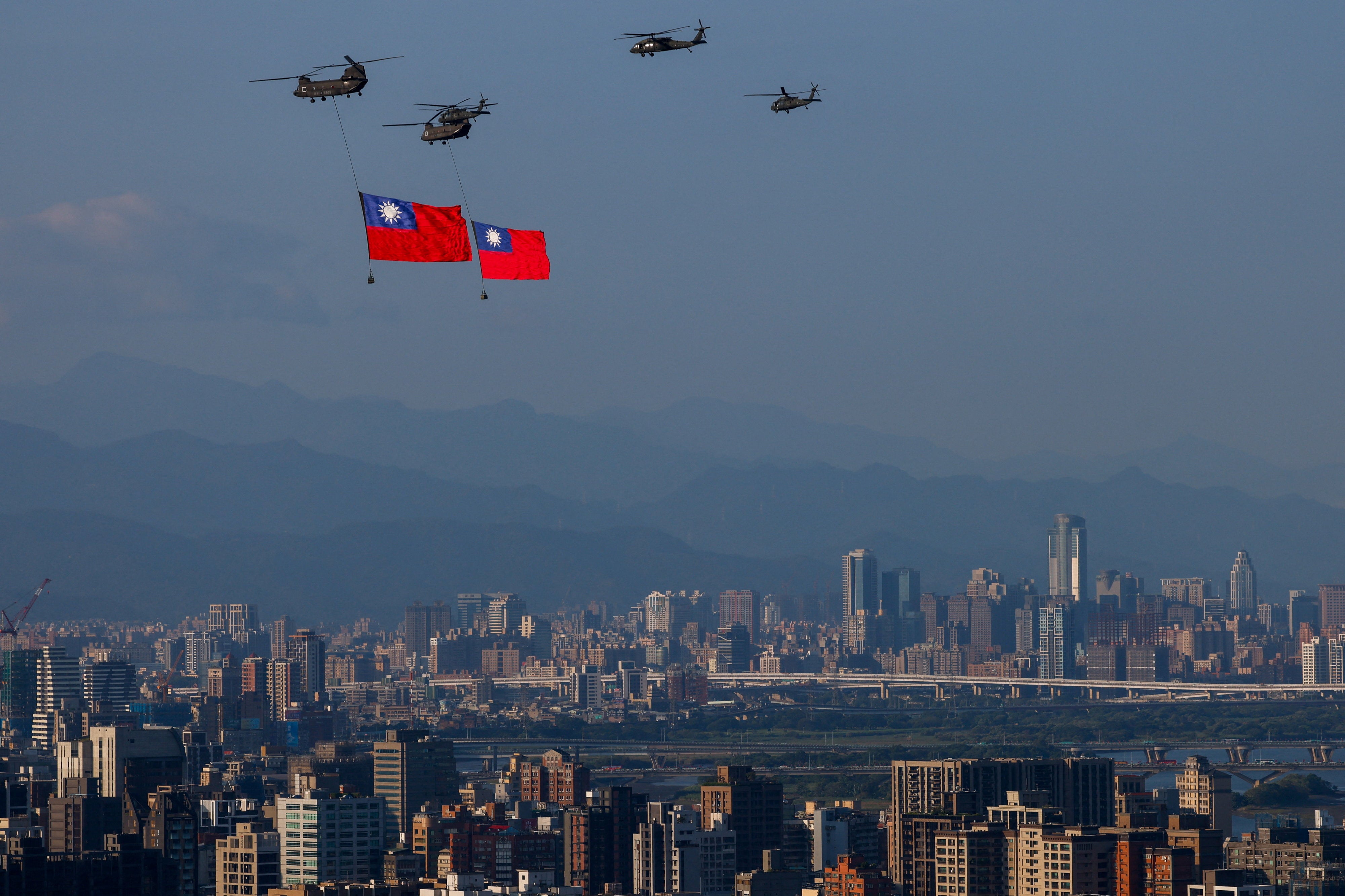 Helicopters carries Taiwan's national flag during a rehearsal for the country’s National Day celebrations