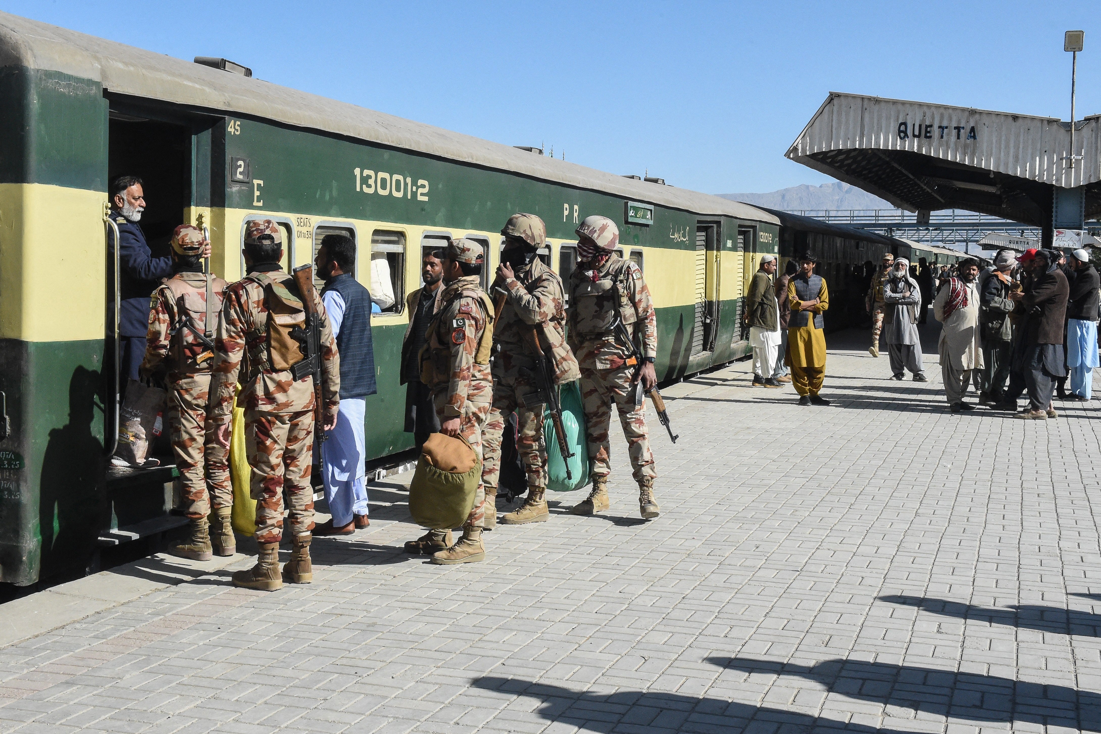 Pakistani Army personnel board the Jaffar Express passenger trainÂ as it resumes its services after an attack by ethnic Baloch separatists