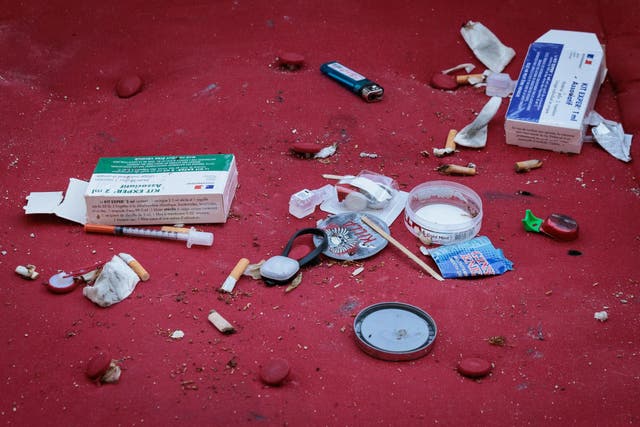 <p>Photograph shows syringes used by drug addicts and boxes containing HIV and hepatitis prevention tool, thrown on a mattress</p>