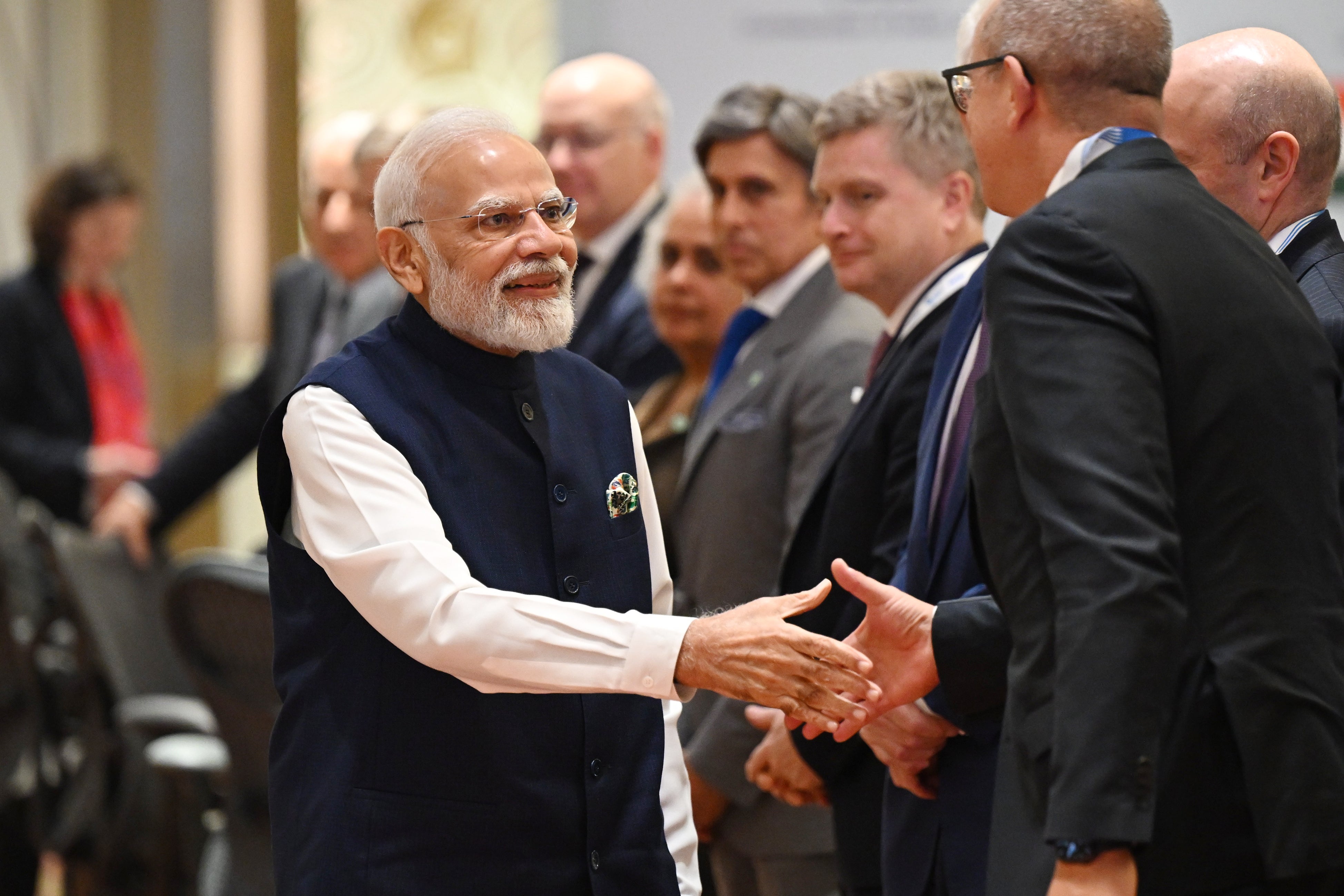 Narendra Modi greets delegates at a conference