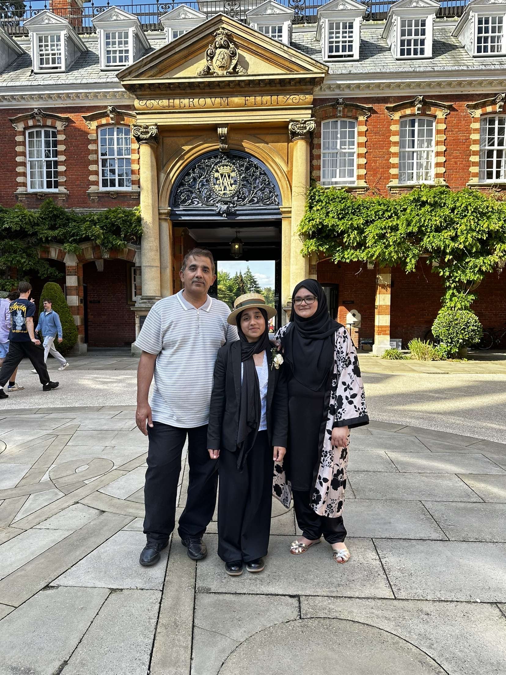 Ms Ahmed with her parents in front of Wellington College, where she attended sixth form