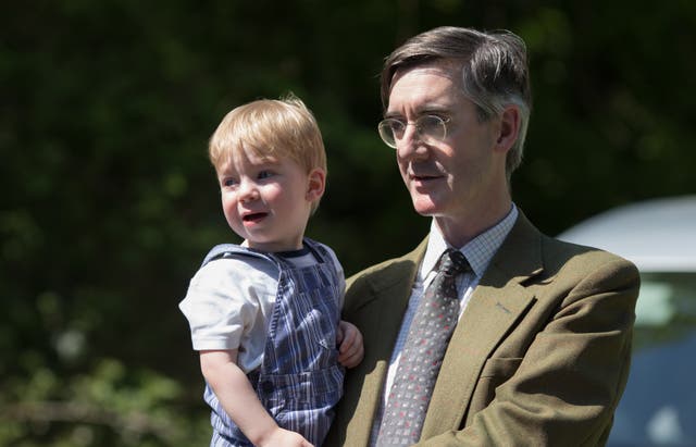 <p>The Conservative politician Jacob Rees-Mogg poses with his son Alfred in 2018</p>