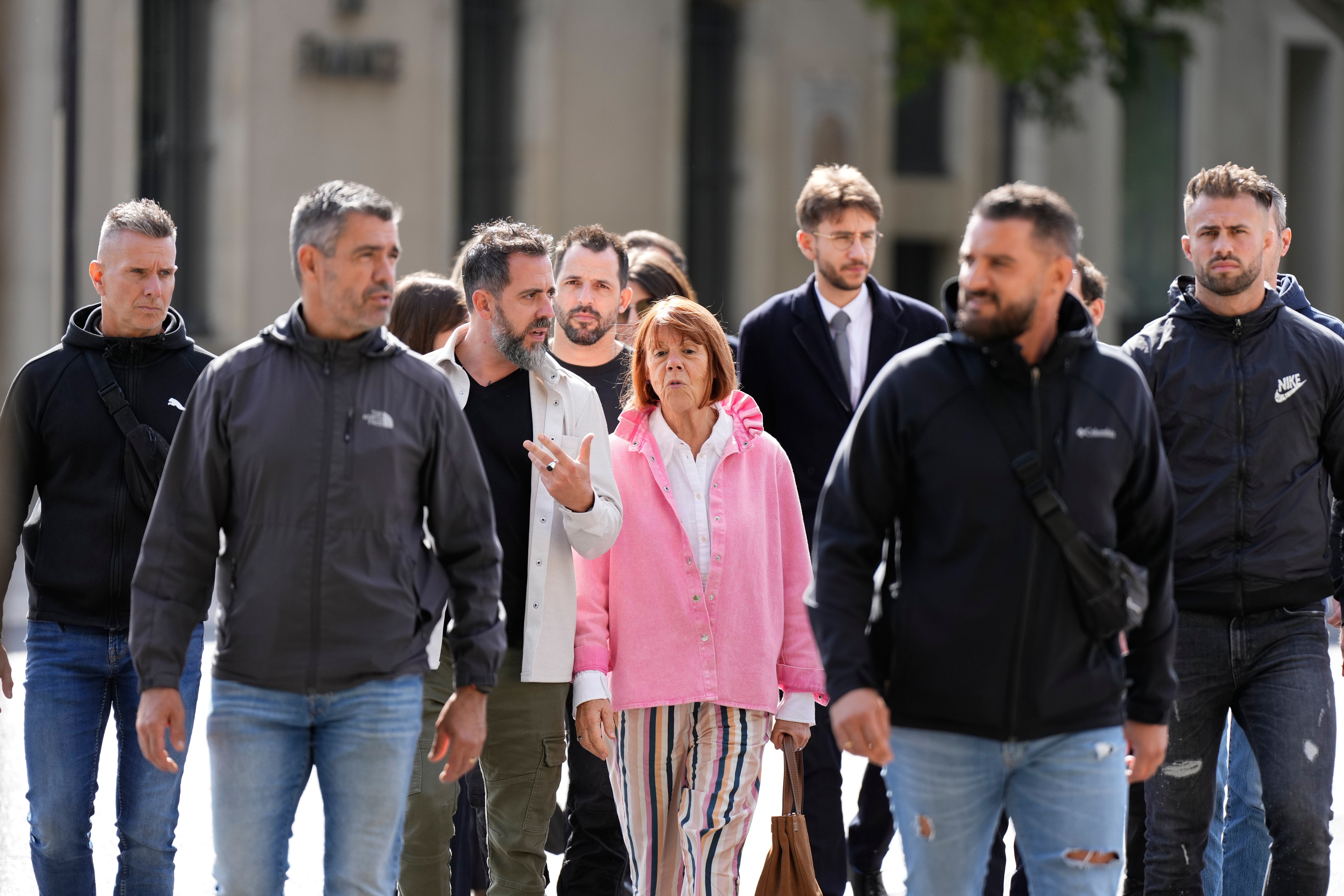 Gisele Pelicot and her son Florian Pelicot, third left, return to the courthouse during the appeals trial