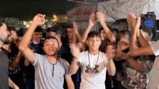 Palestinians celebrate on a street following the news that Israel and Hamas have agreed on Wednesday to the first phase of US president Donald Trump's plan for Gaza
